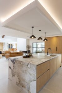 Ligna oak island drawers beneath a veined stone worktop
