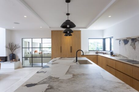 View across the Ligna stone island towards the oak cabinetry and black tap